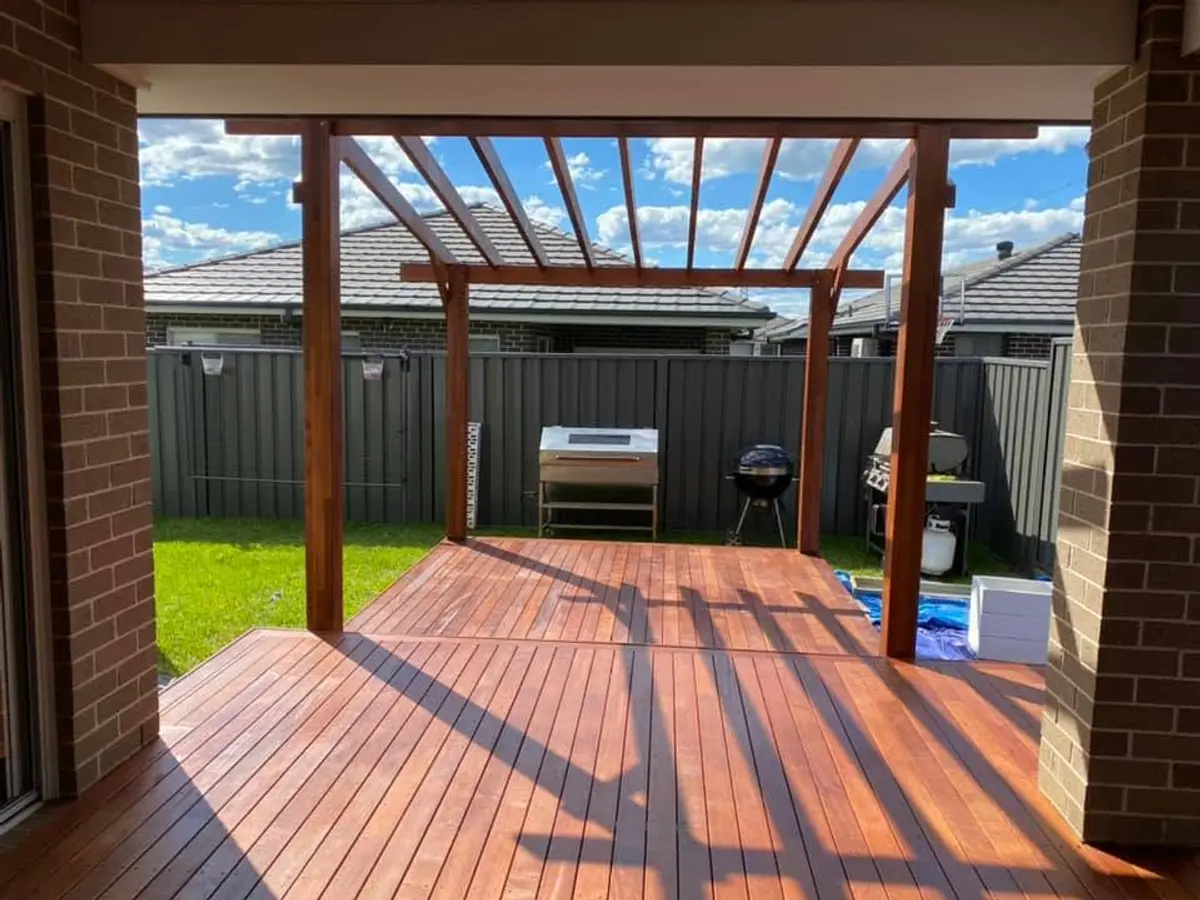 Open pergola over a ground-level deck
